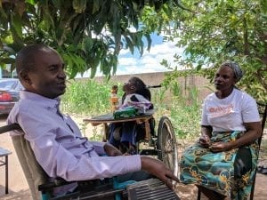 A representative from a disabled people’s organisation in Zimbabwe (left) facilitating a semi-structured interview with a community member and her son, as part of an end-of-program evaluation.