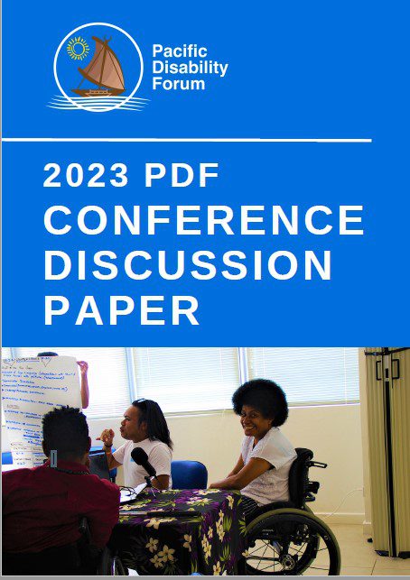 Front page of the 2023 PDF Conference Discussion Paper featuring a group of people in a meeting gathered around a whiteboard, including a person who is a wheelchair user who is smiling.